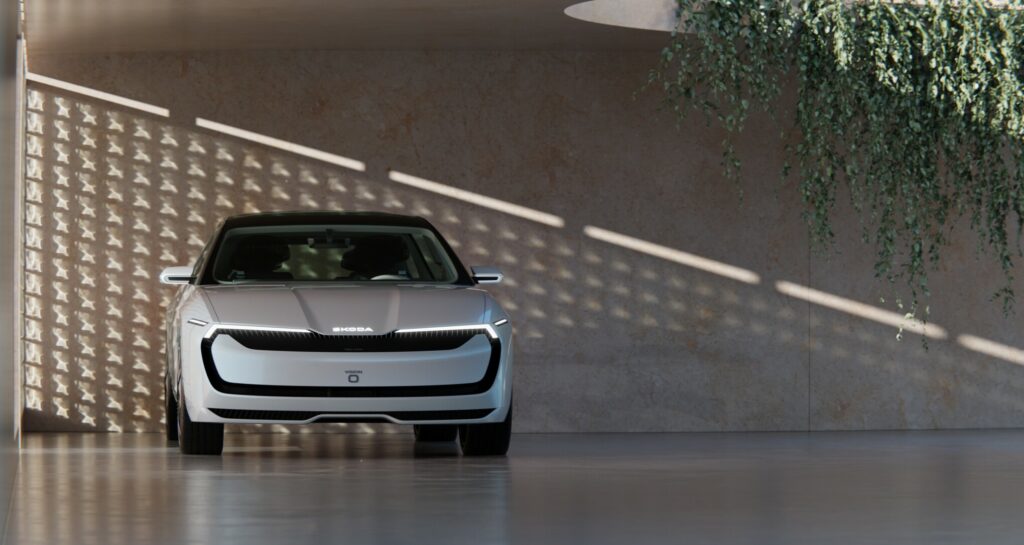 Škoda Vision O vue de face, stationnée dans un cadre architectural sobre et végétalisé.